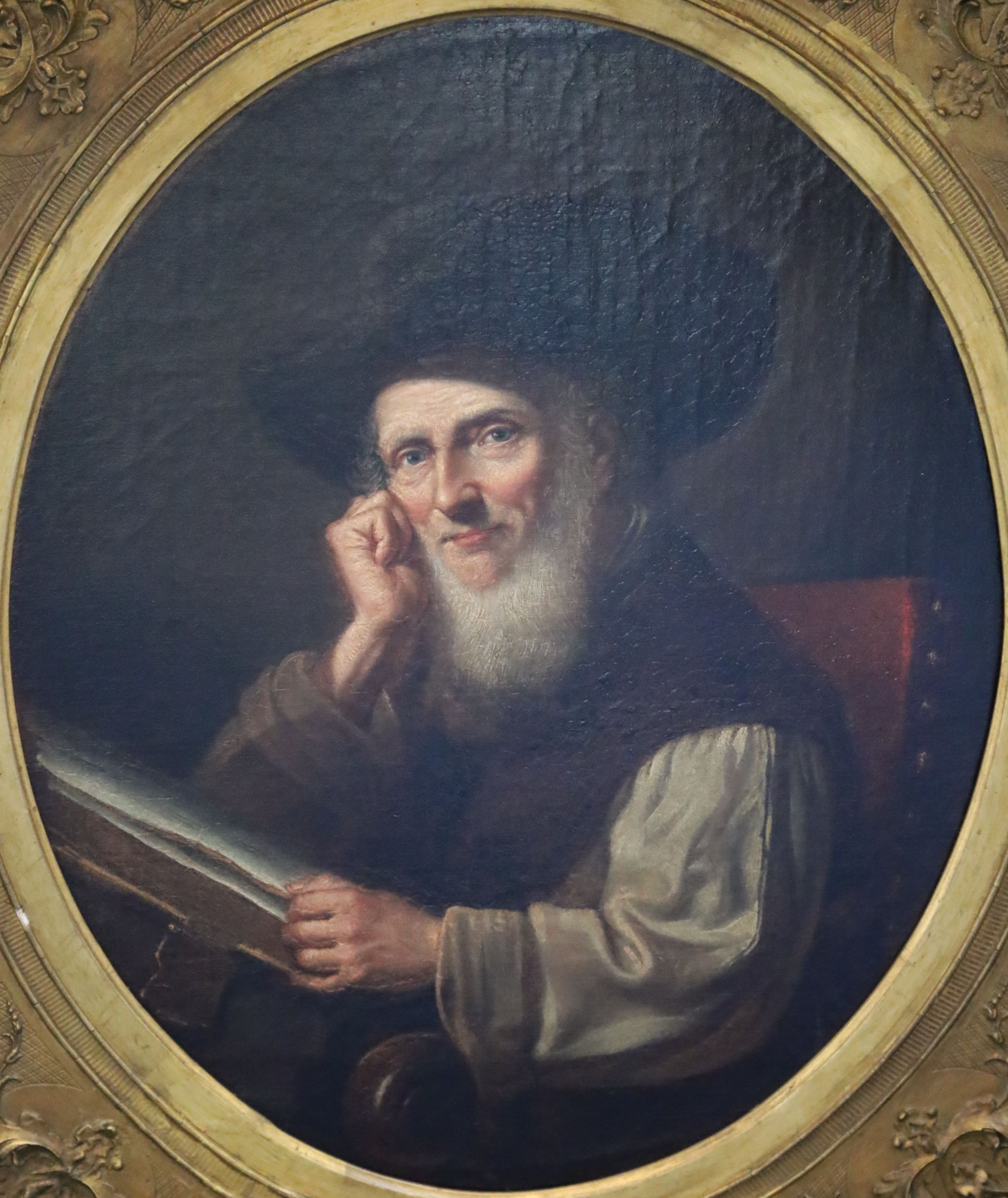 19th century Flemish School Portrait of a 17th century gentleman seated reading a book 56 x 45.75cm.